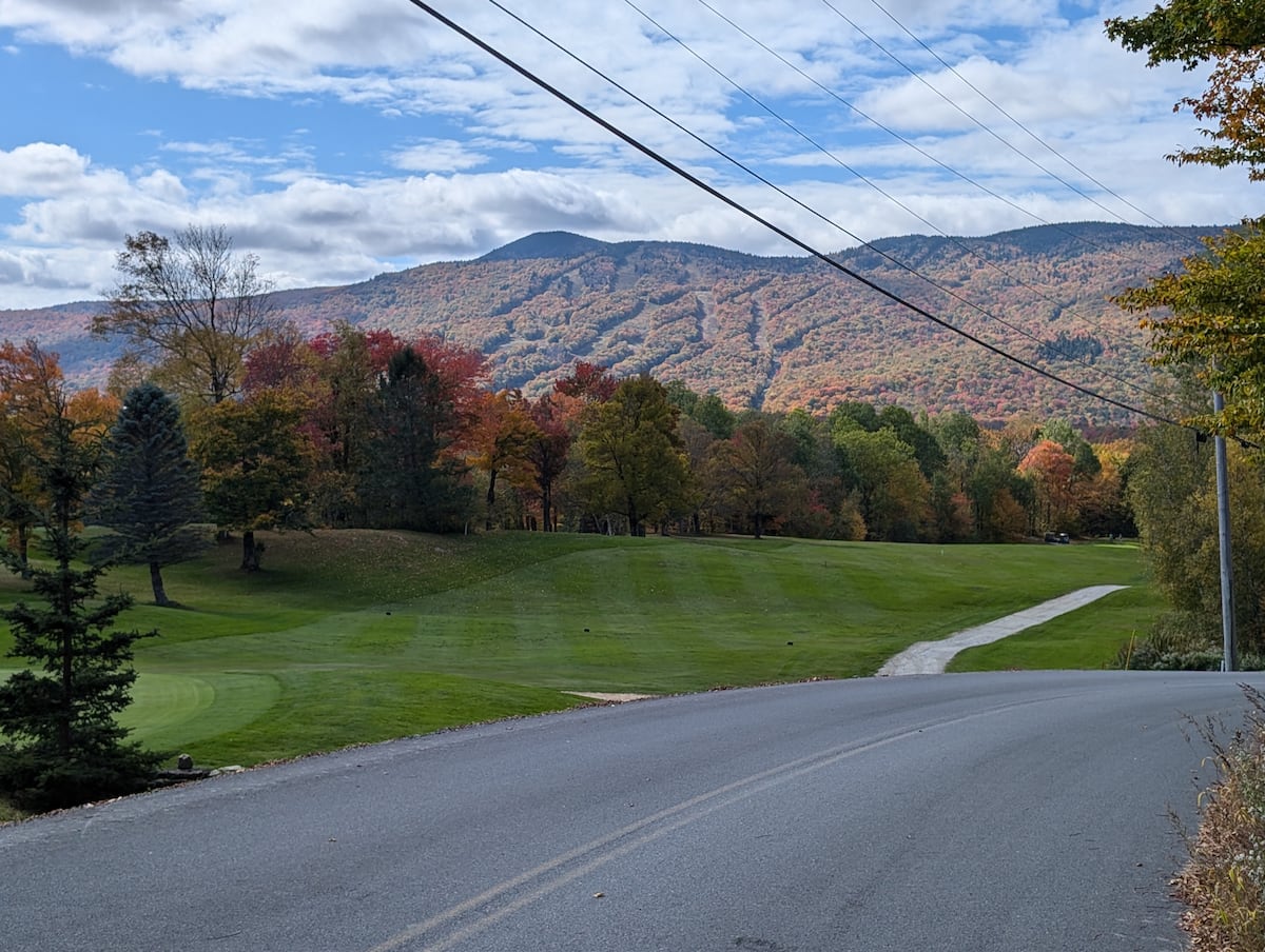 Fall foliage on the mountain above the golf course, on the drive to the Sports Lodge