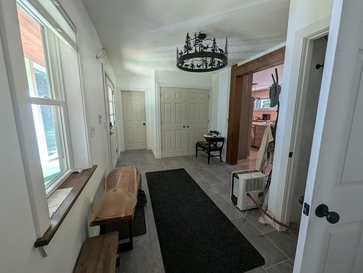 Entry area with the wildlife chandelier, looking through to the kitchen